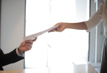 Employee giving paperwork to employer